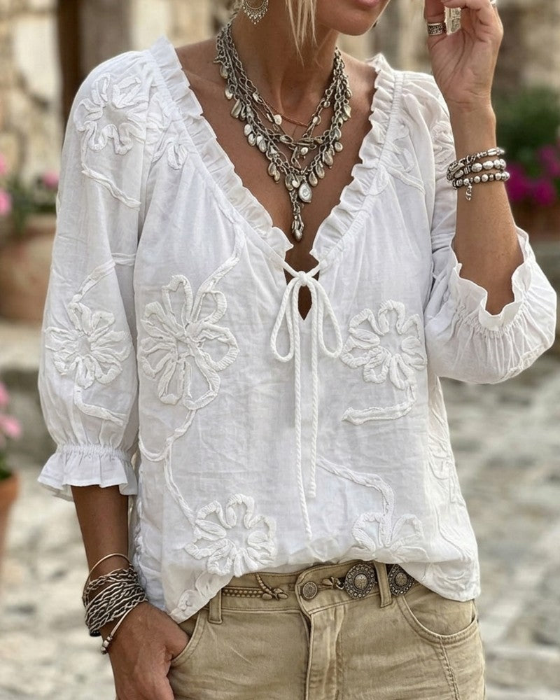 Blusa de algodón 100%, escote en V envolvente, con lazo y volantes