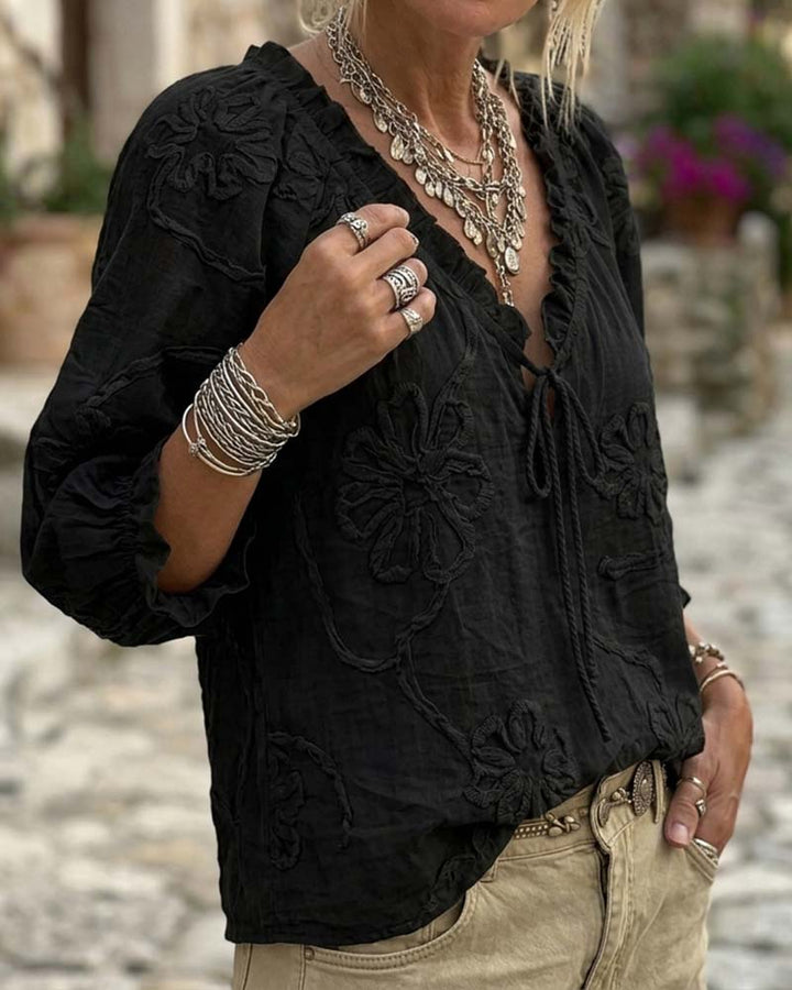 Blusa de algodón 100%, escote en V envolvente, con lazo y volantes