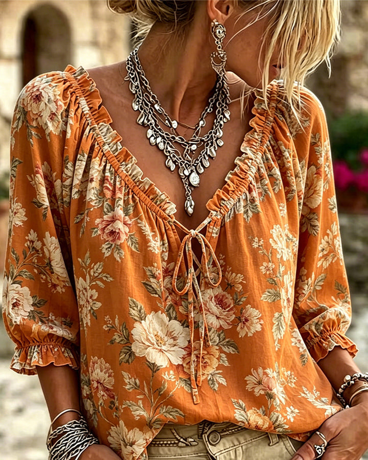 Blusa floral con escote en V y mangas globo