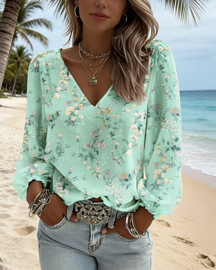 Blusa floral con cuello en V y mangas abullonadas